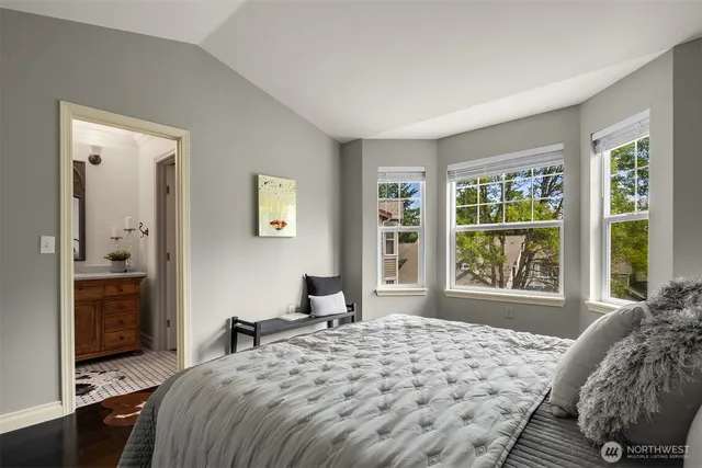 a bedroom with a bed and a large window