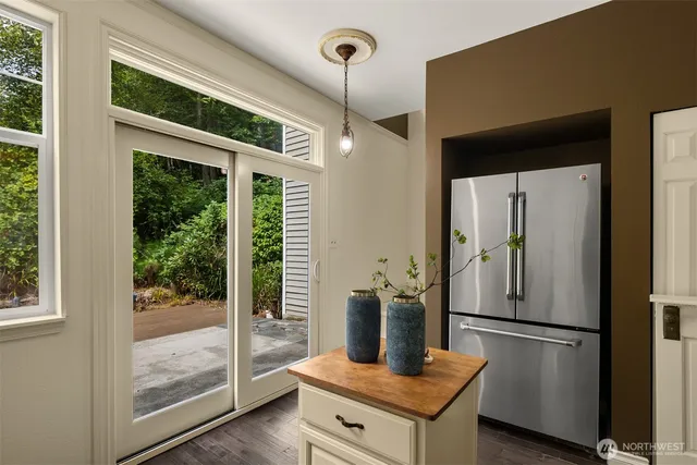a kitchen with stainless steel appliances granite countertop a refrigerator and a glass door