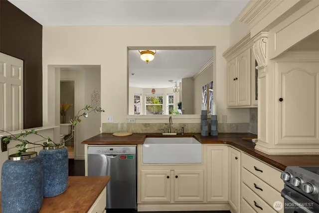 a view of a road with plants and large trees