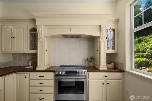 a kitchen with granite countertop a stove oven and sink