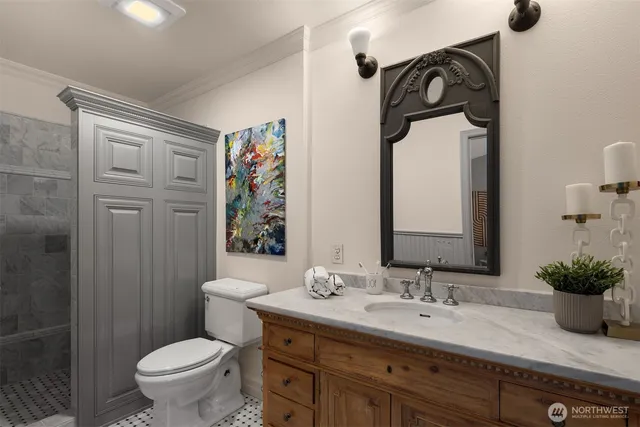 a bathroom with a granite countertop sink toilet and shower