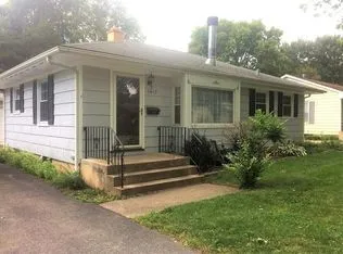 a view of a house with potted plants and a yard