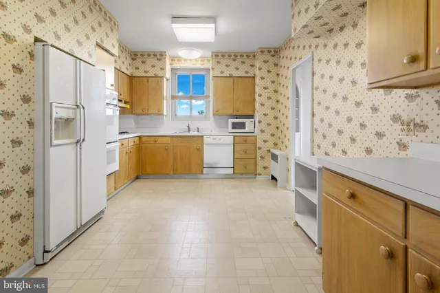 a kitchen with a refrigerator and a stove top oven