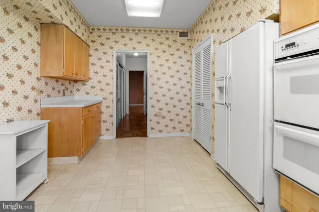 a view of a kitchen with a sink and a refrigerator