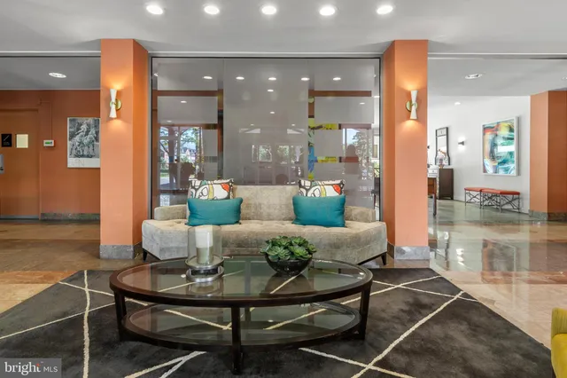 a living room with furniture and a dining table with wooden floor