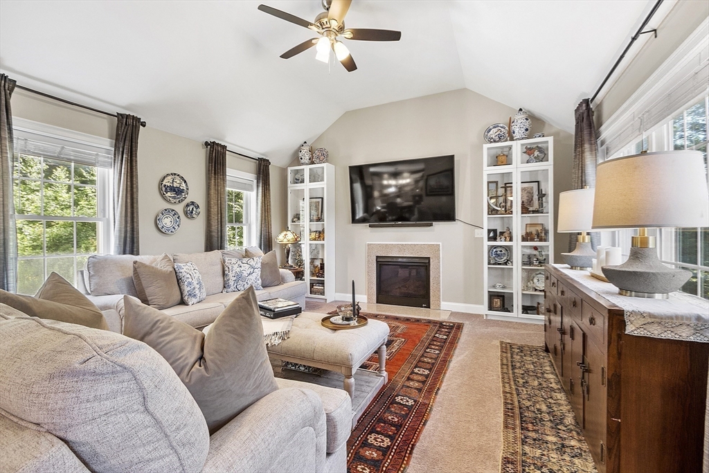 100 Platts Road Ashburnham, MA 01430 - Photo 16 of 42 a living room with furniture a flat screen tv and a fireplace
