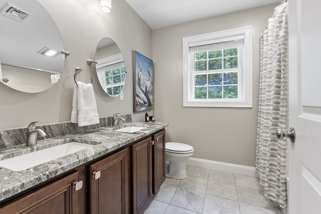100 Platts Road Ashburnham, MA 01430 - Photo 27 of 42 a bathroom with a granite countertop sink a toilet and a mirror