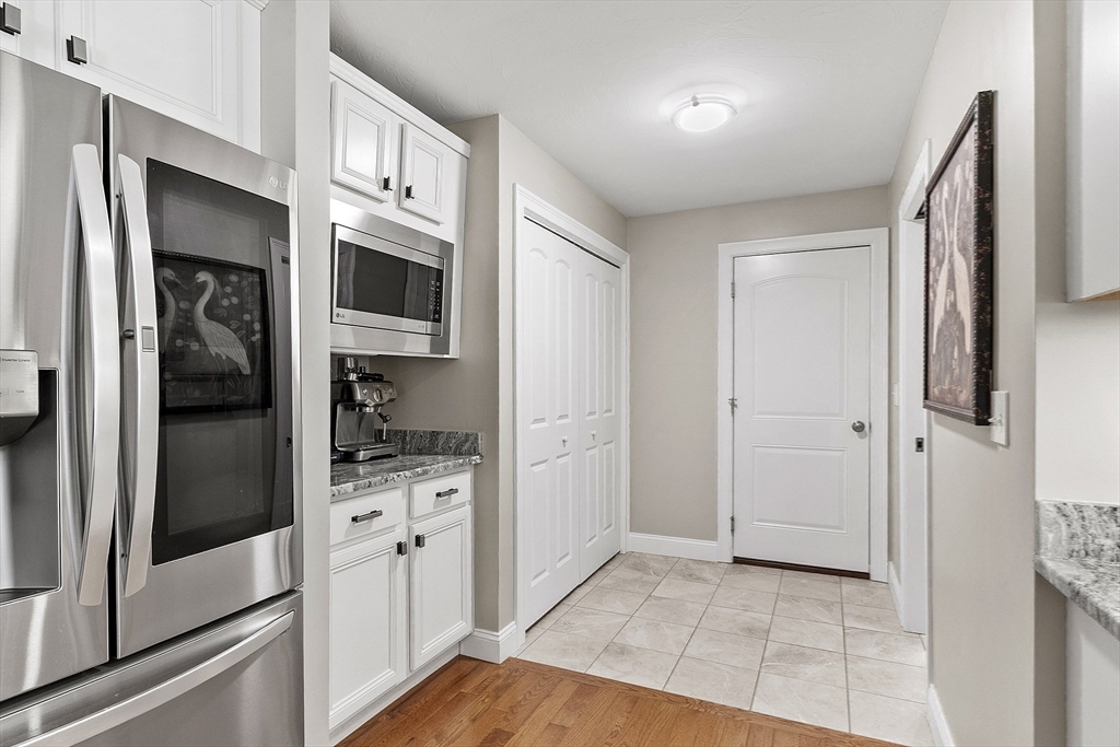 100 Platts Road Ashburnham, MA 01430 - Photo 29 of 42 a kitchen with stainless steel appliances granite countertop a refrigerator and a stove