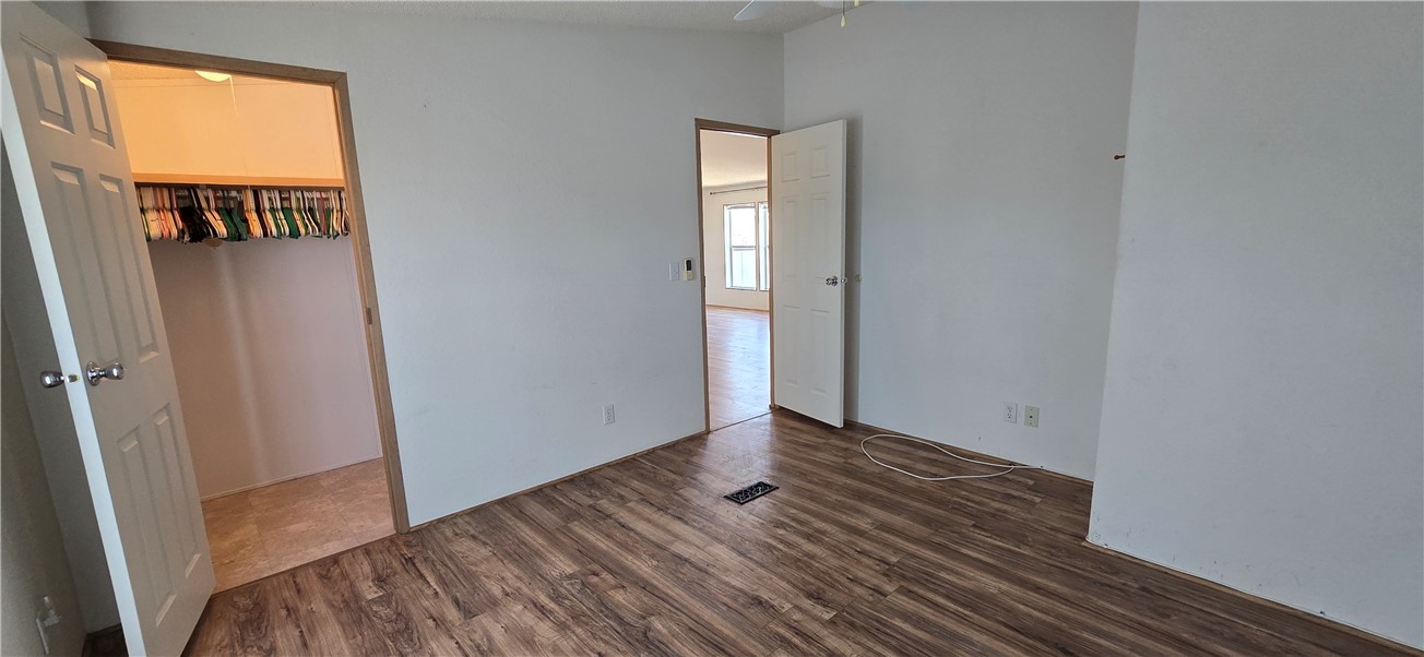 7485 Estrella Road Golden Valley, AZ 86413 - Photo 53 of 76 a view of an empty room with wooden floor and a window