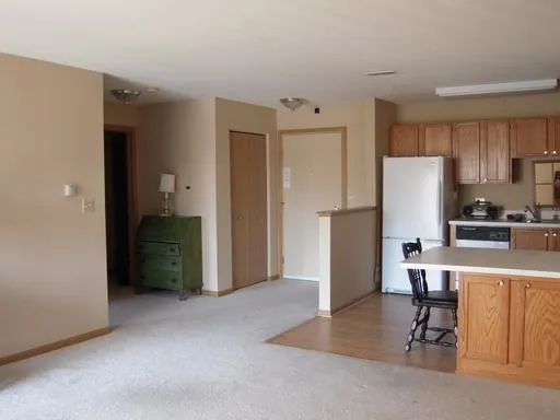 a kitchen with stainless steel appliances a refrigerator and a stove top oven
