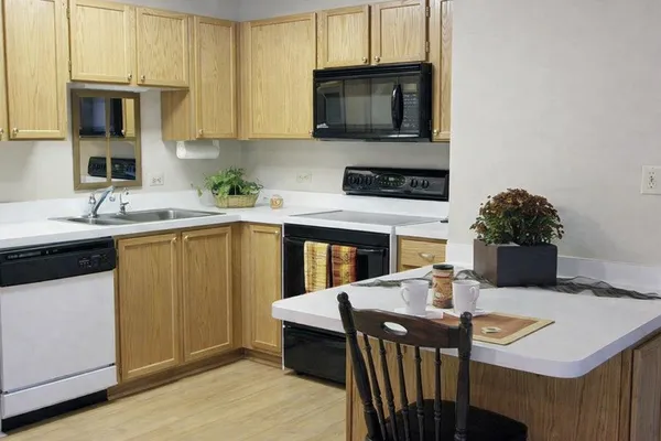 a kitchen with a sink a stove and cabinets