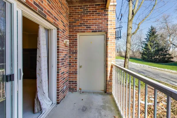 a view of a porch with a floor to ceiling window