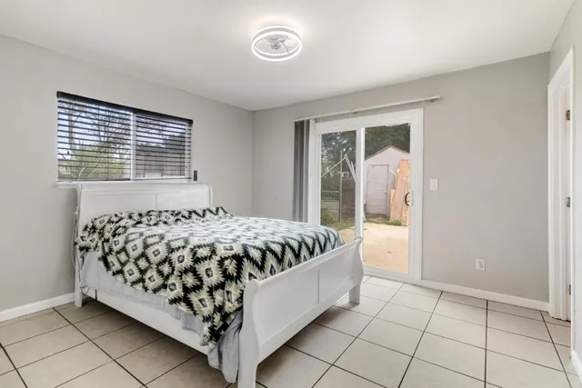 a bed sitting in a bedroom next to a window