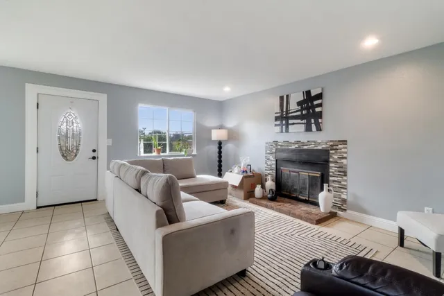 a living room with furniture and a fireplace