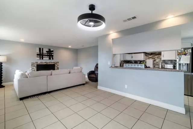 a living room with furniture and kitchen view