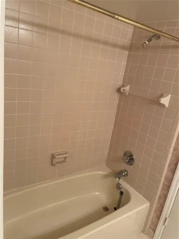 a white bath tub and a shower