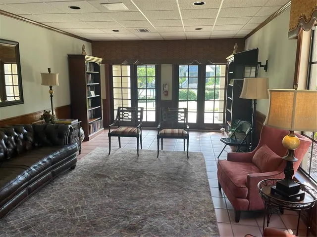 a living room with furniture and a floor to ceiling window