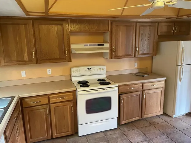 a kitchen with cabinets and a stove top oven