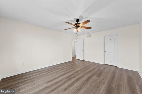 a view of a room with wooden floor and windows
