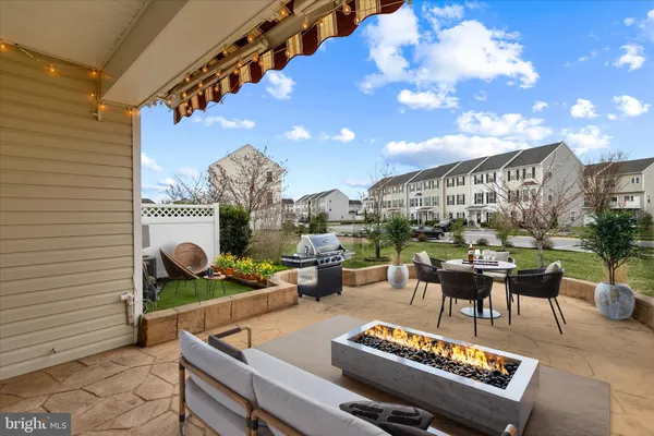 a view of a house with a yard patio and fire pit