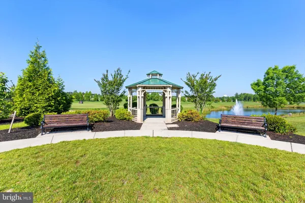 a view of a backyard with swimming pool and sitting area