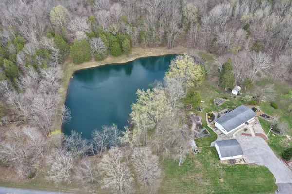 an aerial view of a house with a yard