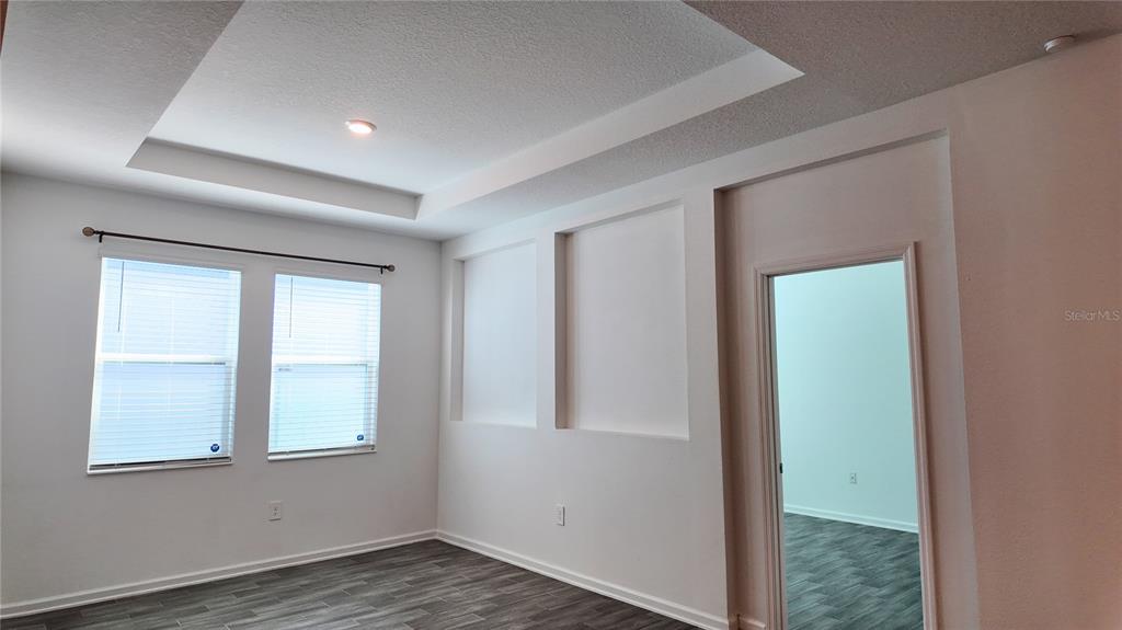 6366 Lakepine Street St. Cloud, FL 34771 - Photo 14 of 22 an empty room with wooden floor and windows