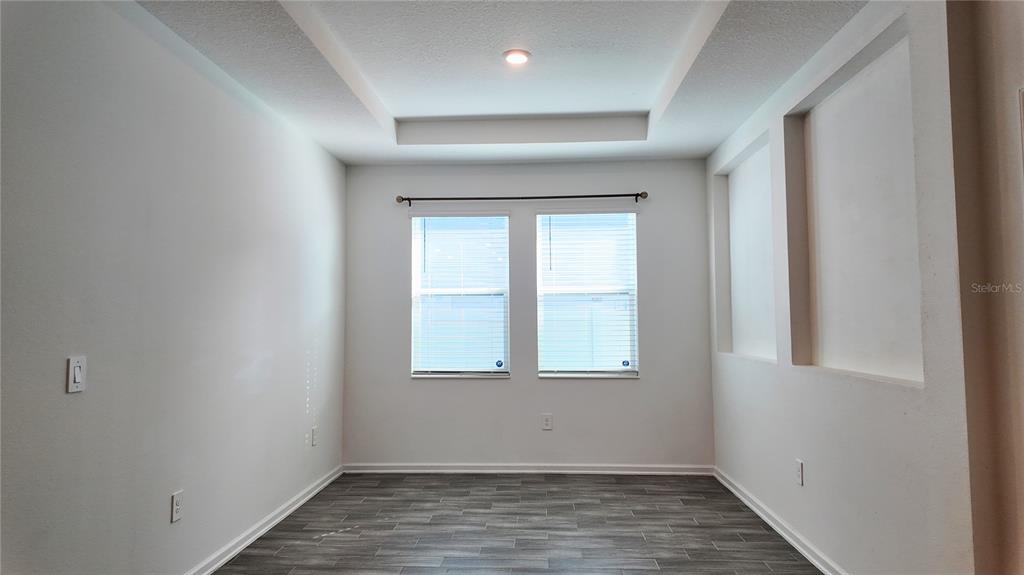 6366 Lakepine Street St. Cloud, FL 34771 - Photo 15 of 22 an empty room with wooden floor and windows