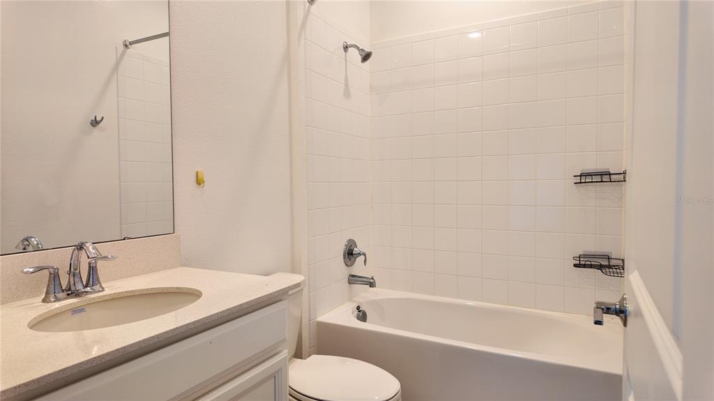 6366 Lakepine Street St. Cloud, FL 34771 - Photo 20 of 22 a bathroom with a sink toilet a bathtub and shower