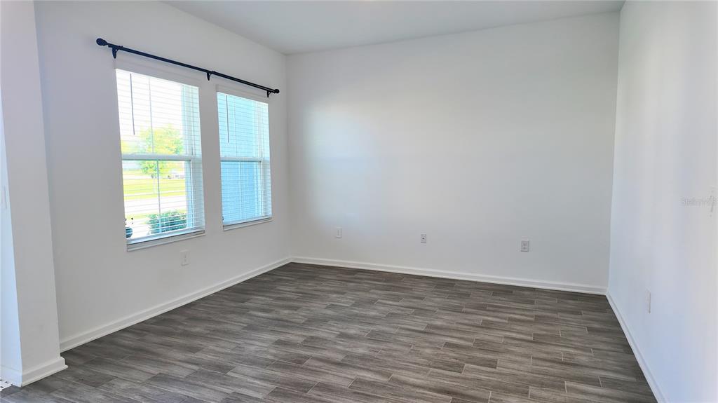 6366 Lakepine Street St. Cloud, FL 34771 - Photo 5 of 22 a view of an empty room with wooden floor and a window