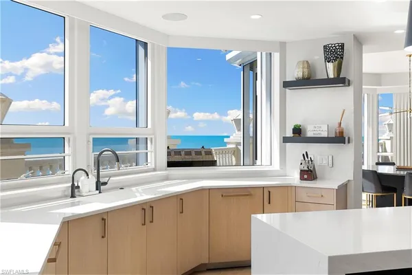 a kitchen with a sink and a large window