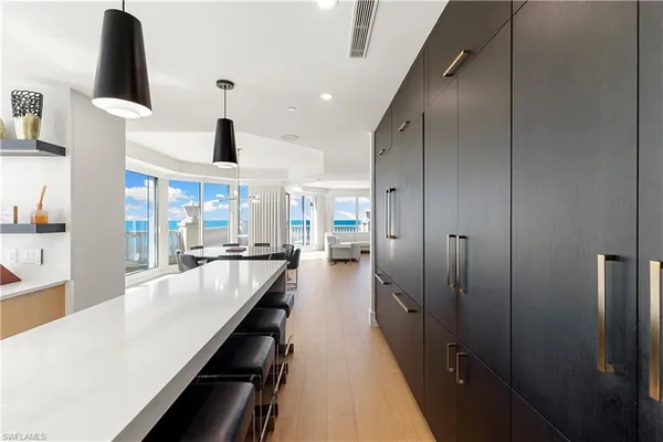 a large kitchen with stainless steel appliances a large counter top