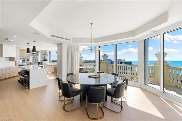 a dining room with furniture window wooden floor and a chandelier