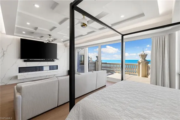 a bedroom with a large bed and a flat screen tv