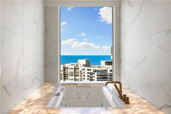 a view of a bathroom with a tub and shower