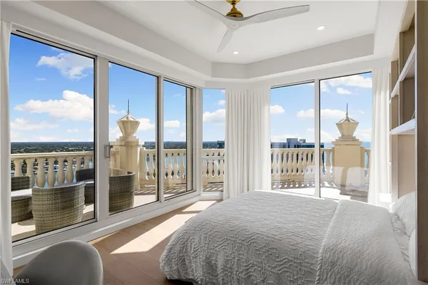 a bedroom with a large bed and a large window