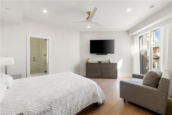 a bedroom with a bed and a flat screen tv