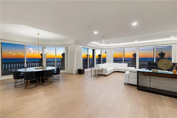 a living room with furniture and a pool table