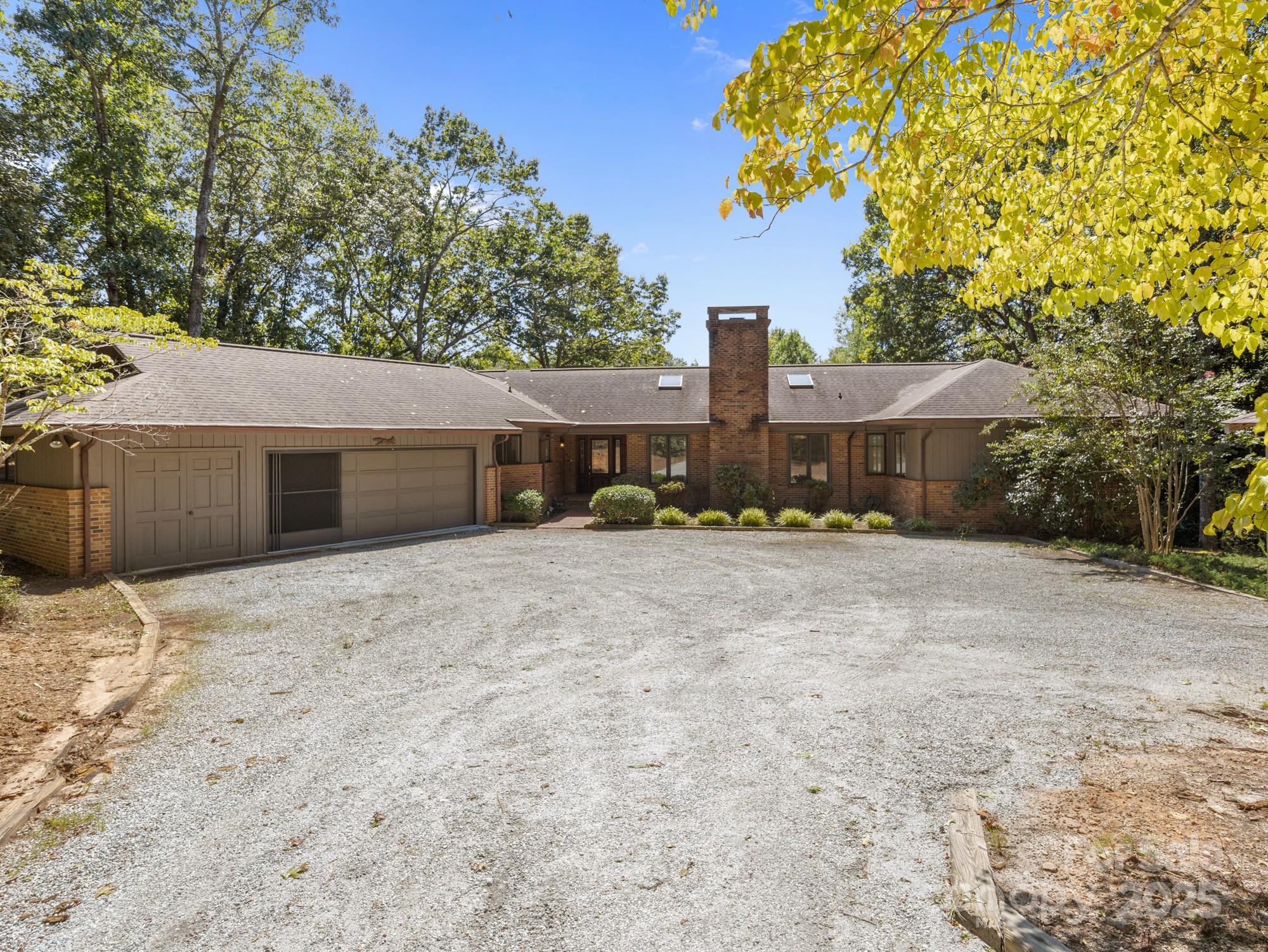 831 Hooper Creek Road Tryon, NC 28782 - Photo 1 of 48 a front view of a house with a yard and garage
