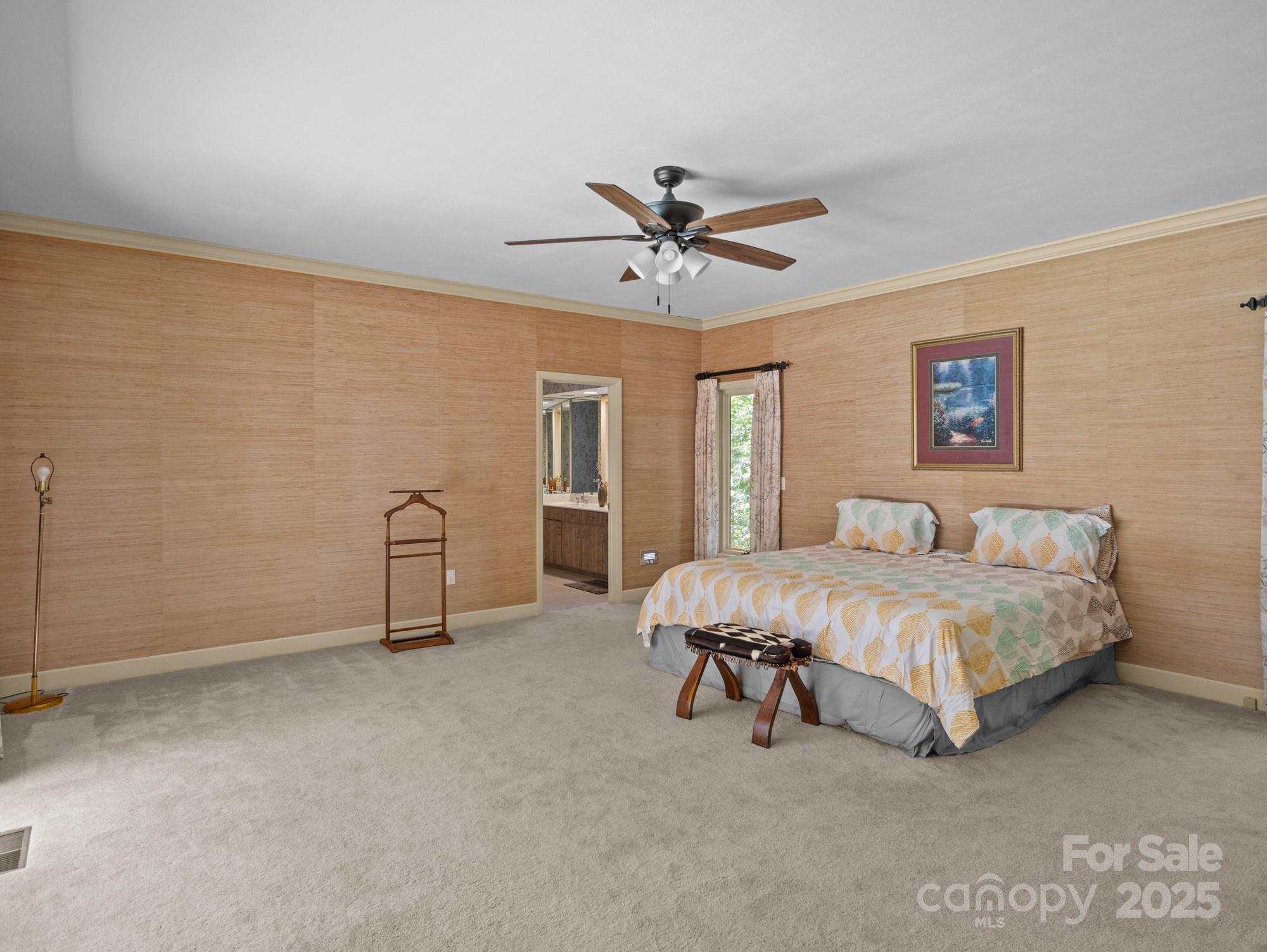 831 Hooper Creek Road Tryon, NC 28782 - Photo 18 of 48 a spacious bedroom with a bed and a ceiling fan