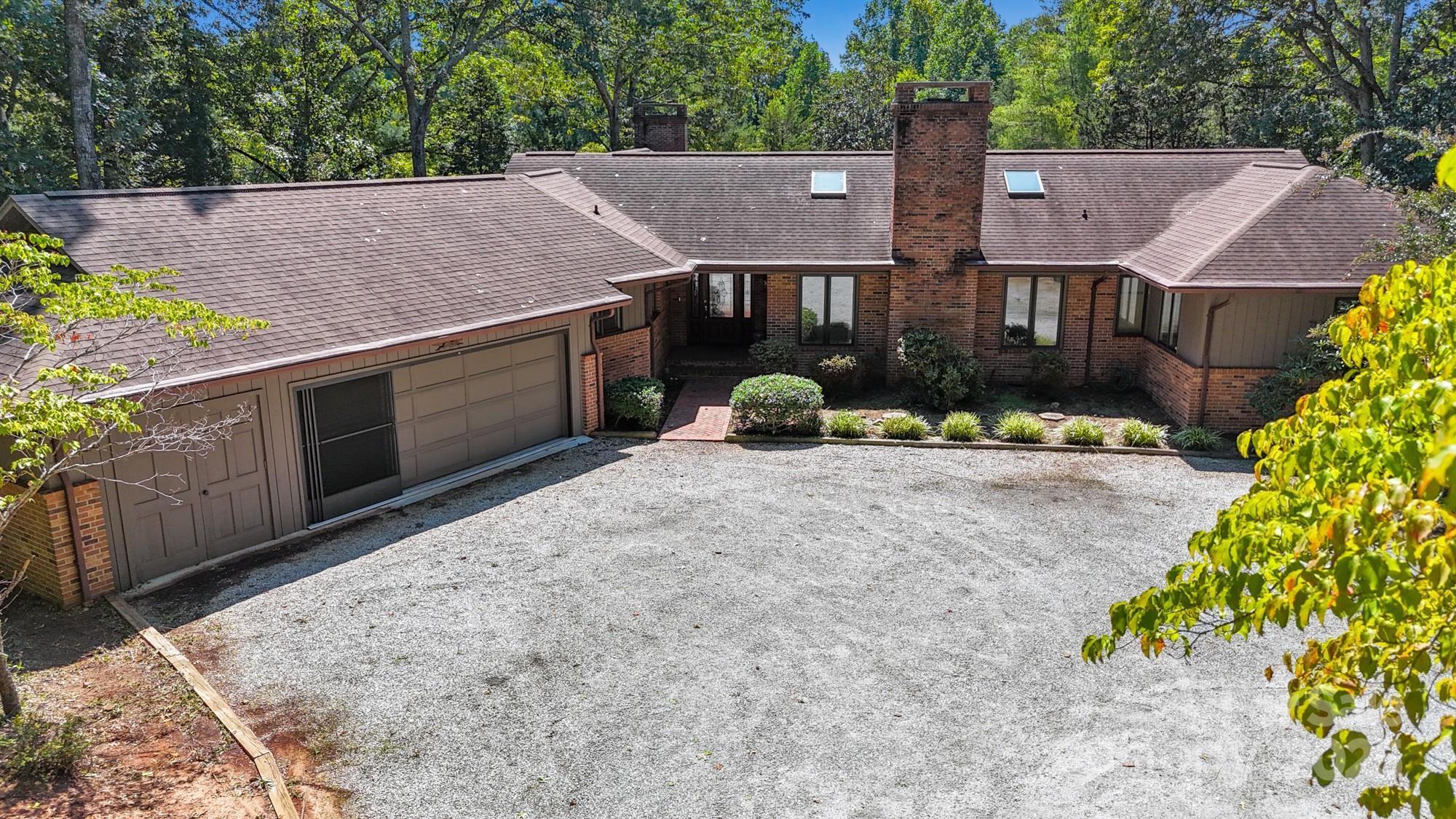 831 Hooper Creek Road Tryon, NC 28782 - Photo 2 of 48 an aerial view of a house with a yard and large tree