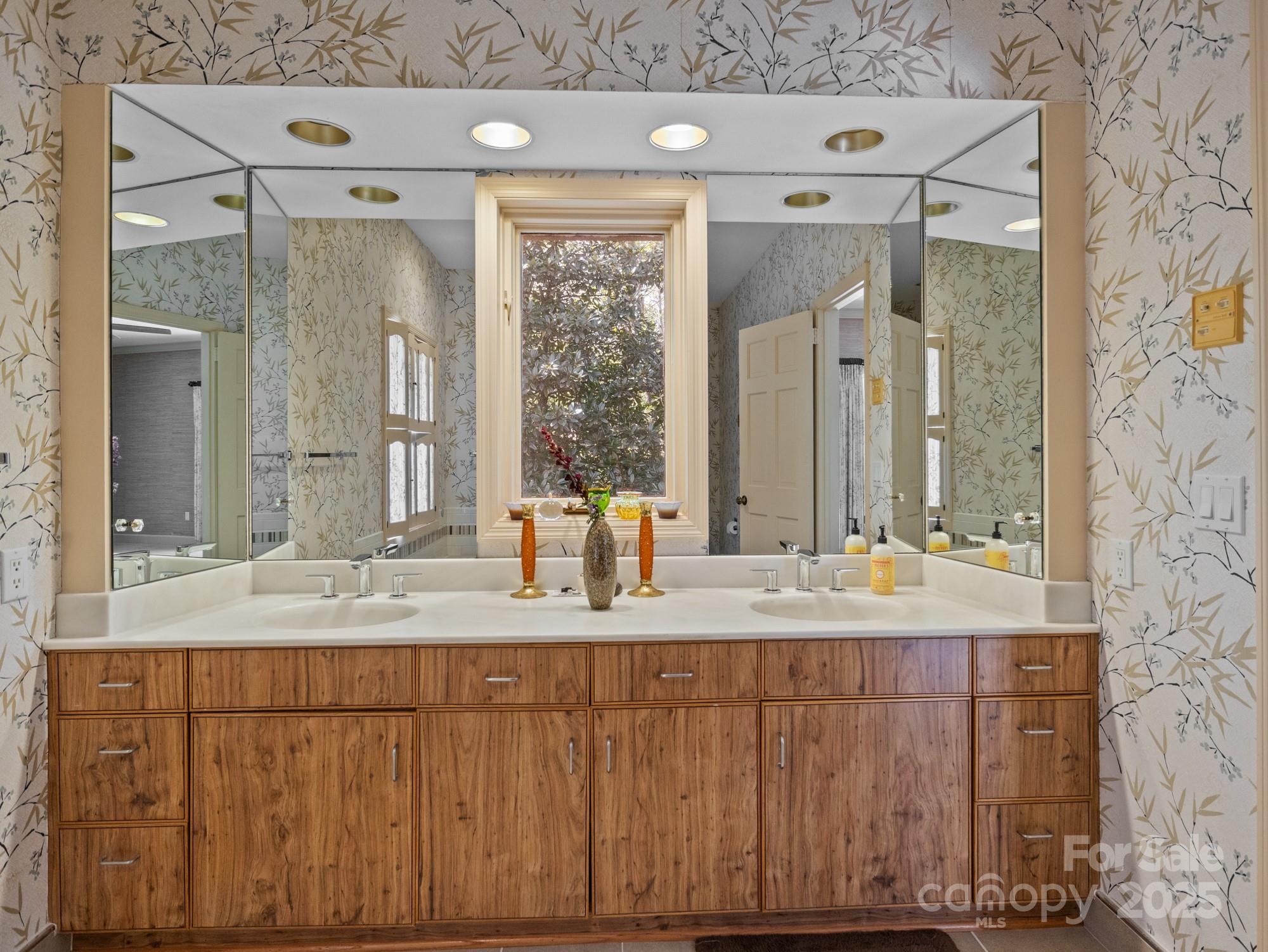 831 Hooper Creek Road Tryon, NC 28782 - Photo 22 of 48 a bathroom with a granite countertop sink a mirror and a shower