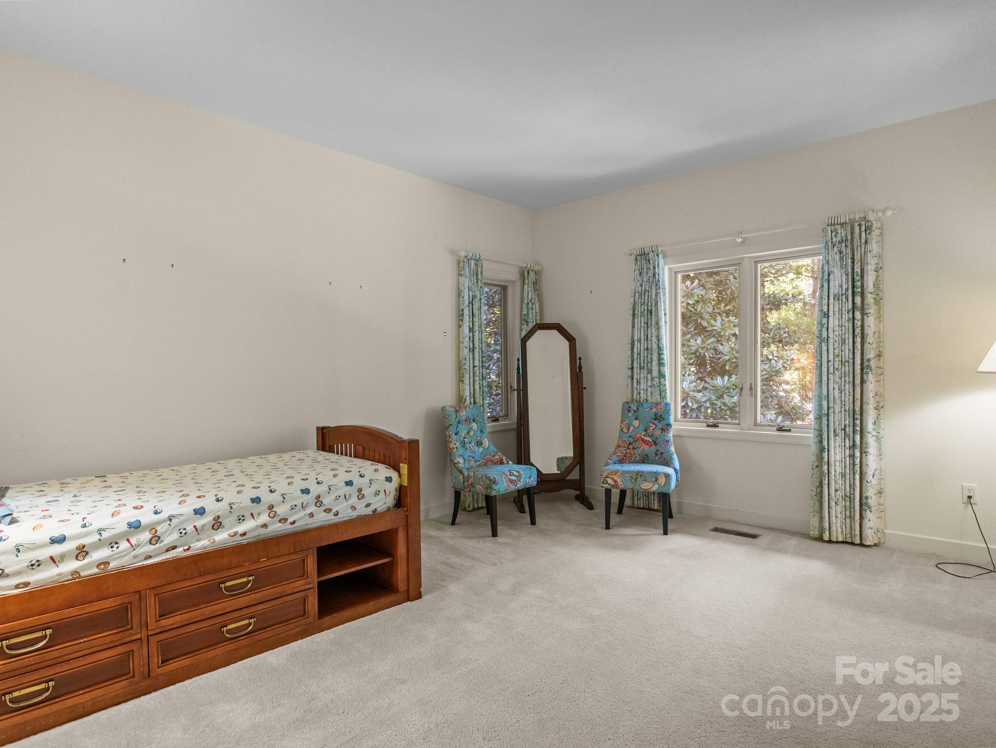 831 Hooper Creek Road Tryon, NC 28782 - Photo 27 of 48 a bed room with a bed and a chair