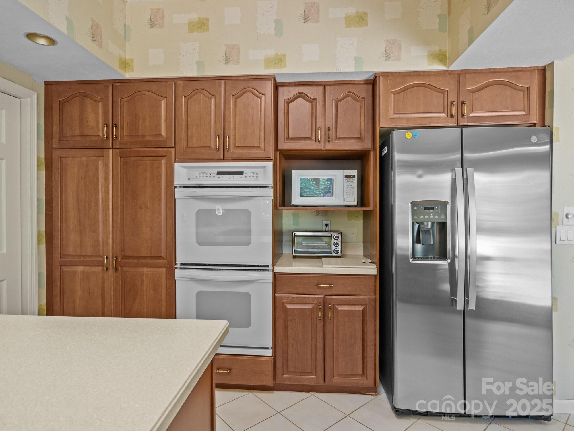 831 Hooper Creek Road Tryon, NC 28782 - Photo 8 of 48 a kitchen with stainless steel appliances granite countertop a refrigerator and cabinets