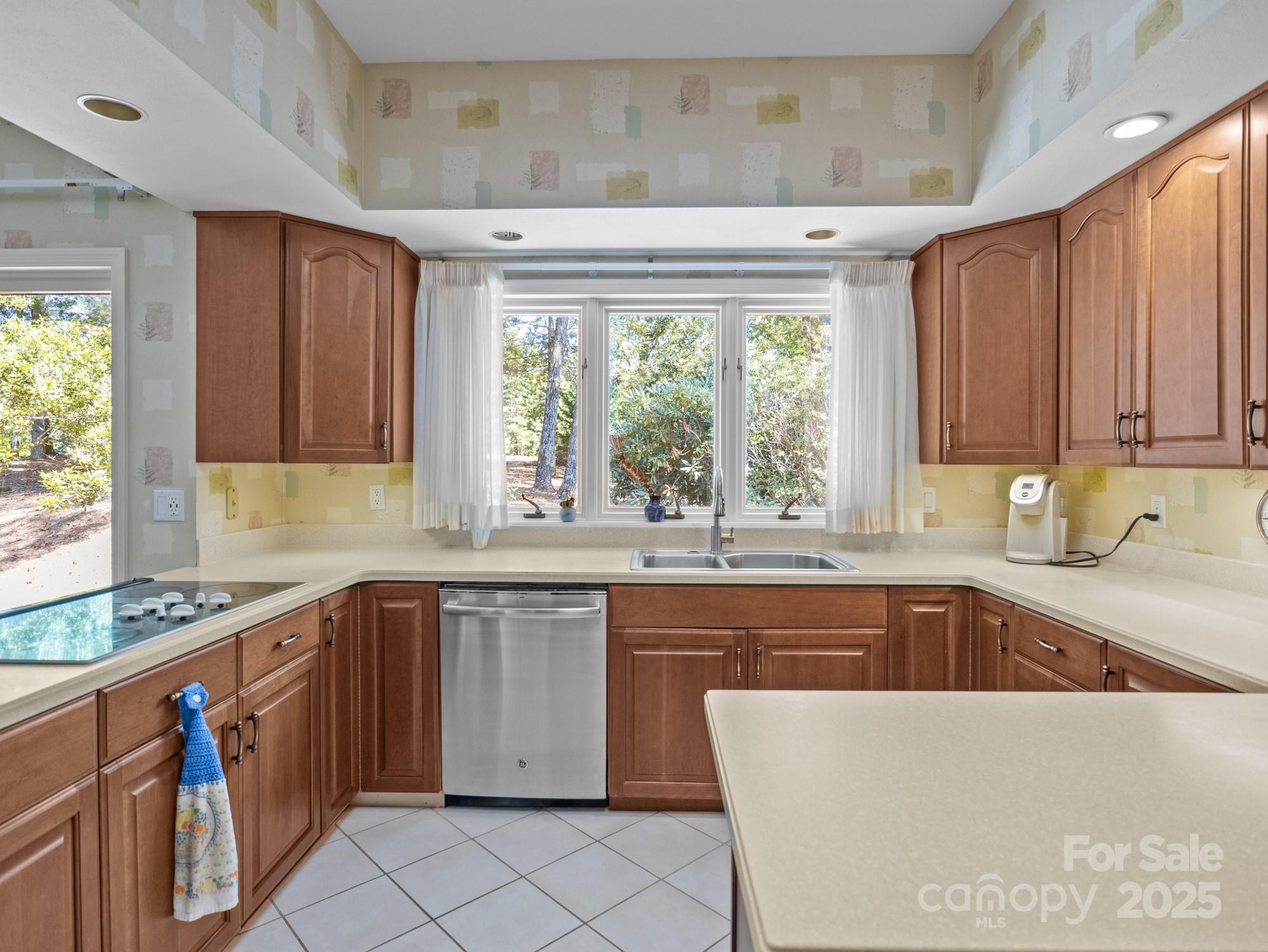 831 Hooper Creek Road Tryon, NC 28782 - Photo 9 of 48 a kitchen with a sink window and cabinets