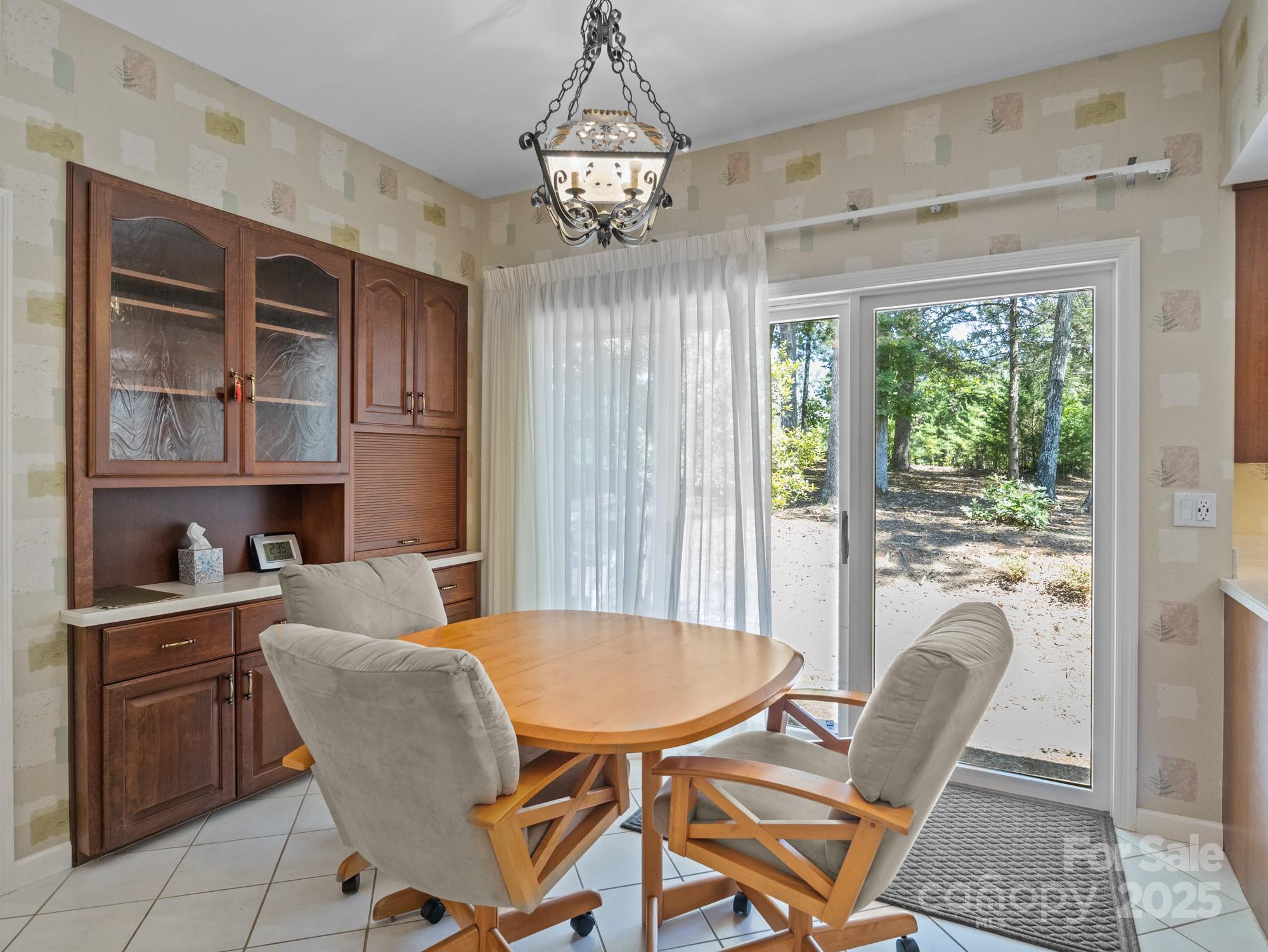 831 Hooper Creek Road Tryon, NC 28782 - Photo 10 of 48 a dining room with furniture a chandelier and window