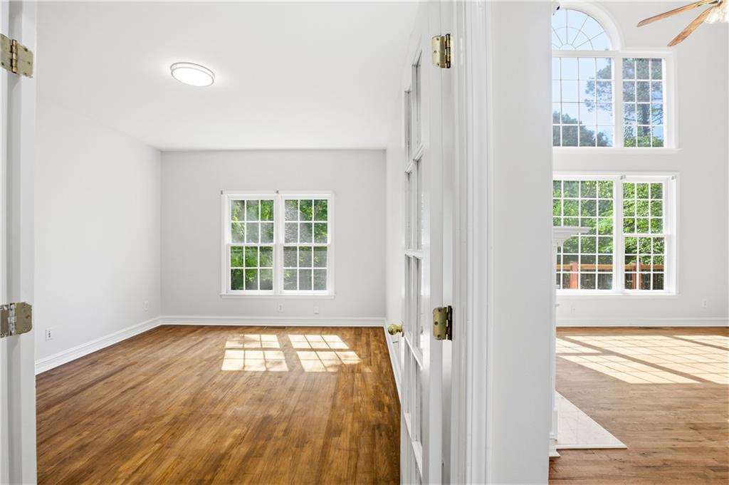 110 Mayes Farm Road Northwest Marietta, GA 30064 - Photo 10 of 49 an empty room with wooden floor and windows