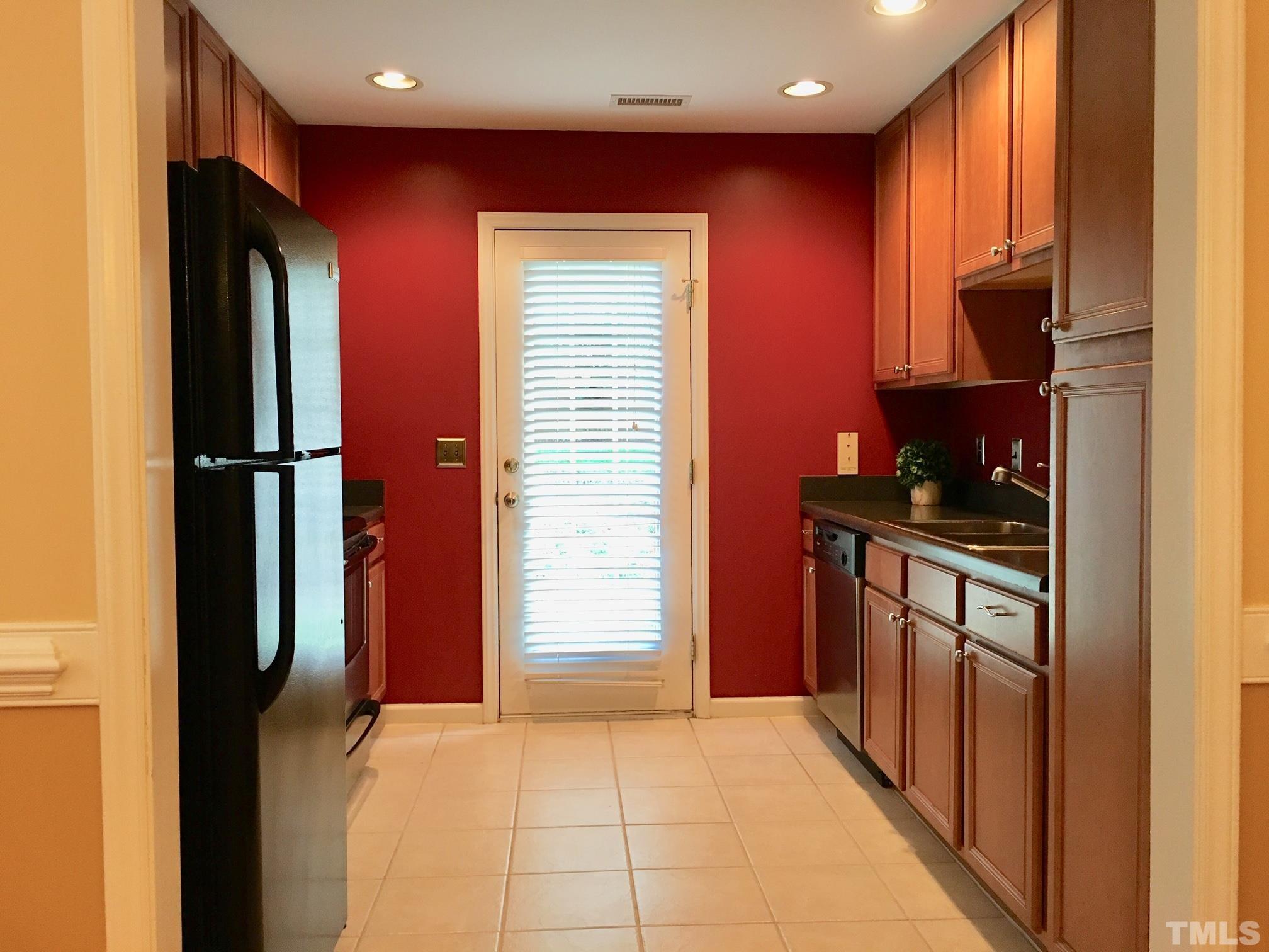 9801 Raleigh, NC 27617 - Photo 11 of 23 a kitchen with stainless steel appliances granite countertop a refrigerator and a stove