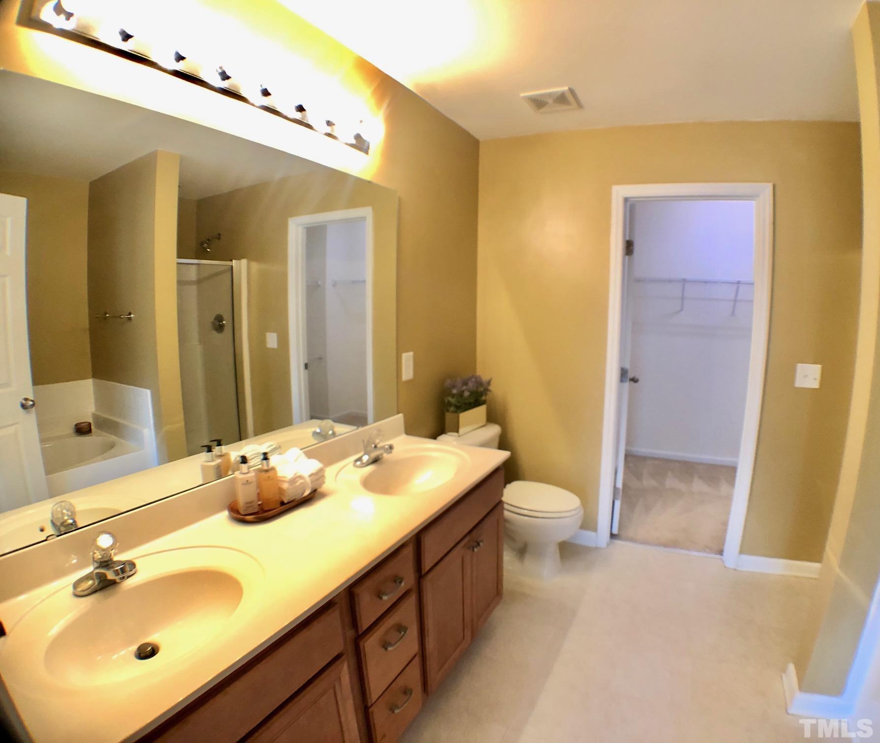 9801 Raleigh, NC 27617 - Photo 20 of 23 a bathroom with a double vanity sink toilet and shower