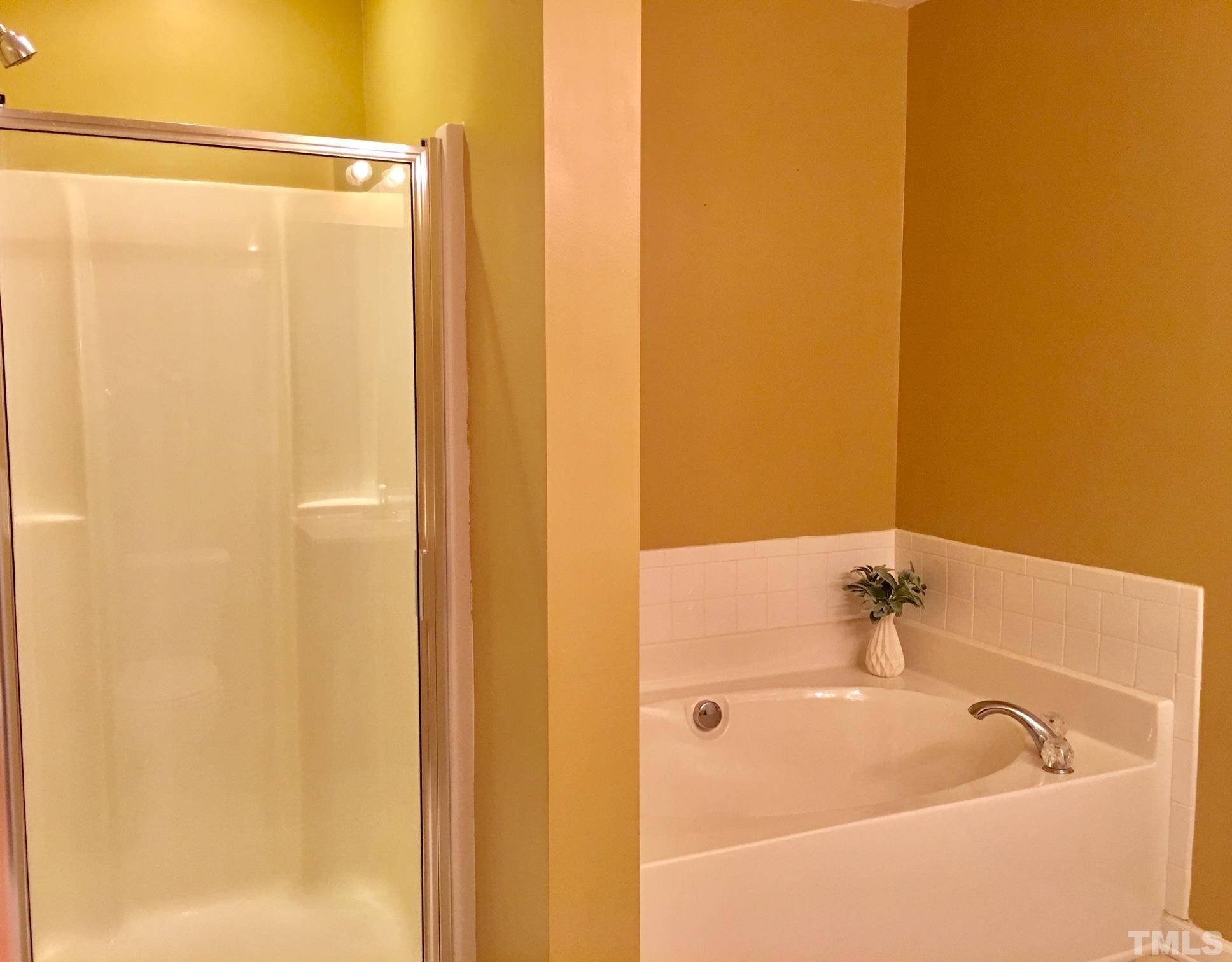9801 Raleigh, NC 27617 - Photo 21 of 23 a bathroom with a bathtub